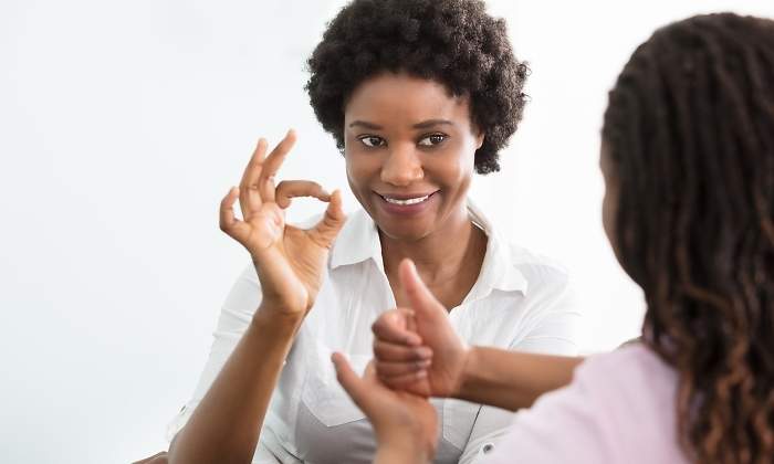 Una mujer se comunica con lengua de signos