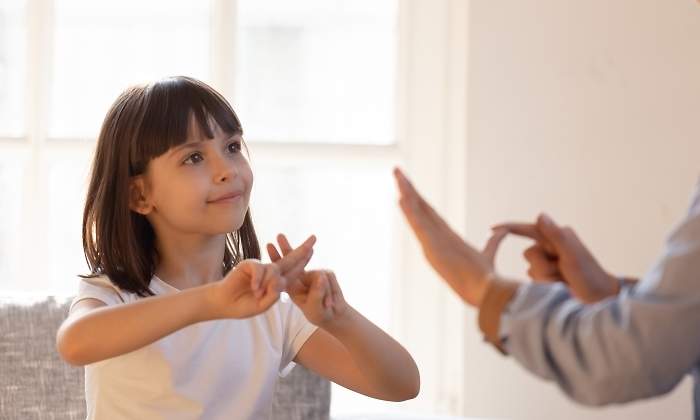 Una nia se comunica con su madre mediante lengua de signos