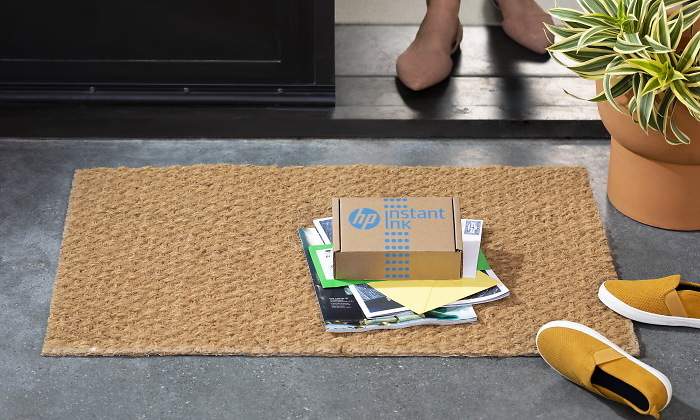 Una caja con cartuchos de tinta de HP sobre un felpudo
