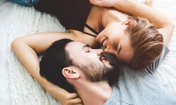 Un-chico-y-una-chica-mirandose-sobre-una-cama-iStock.jpg