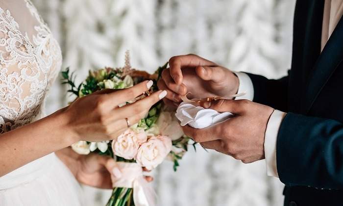 exchange-of-wedding-rings-white-picture-id940217162.jpg